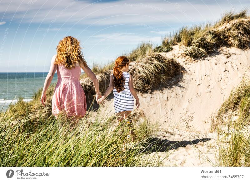 Netherlands, Zandvoort, mother and daughter walking in beach dunes beaches sand dune sand dunes daughters family families Fun having fun funny child children
