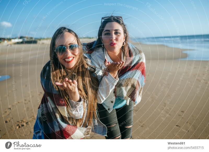 Portrait of two young women on the beach blowing kisses beaches blowing a kiss blow kiss female friends mate friendship best friend bff best friends portrait