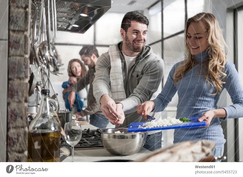 Couple cooking for family and friends in kitchen domestic kitchen kitchens couple twosomes partnership couples people persons human being humans human beings