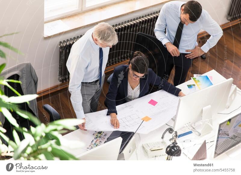 Team of business people in planning office working on blue print offices office room office rooms At Work Planning planned floor plan floor plans ground plan