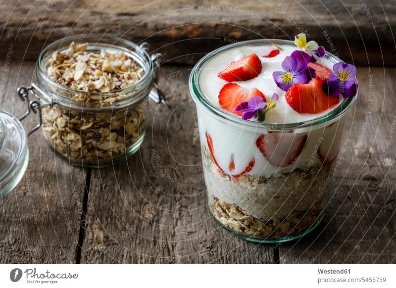 Glass of granola with natural yogurt, strawberries and Horned Violets nobody natural yoghurt plain yoghurt food and drink Nutrition Alimentation Food and Drinks