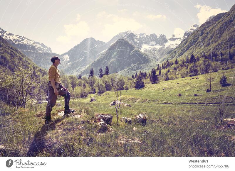 Slovenia, Bovec, man standing on meadow near Soca river men males hiking hike meadows Adults grown-ups grownups adult people persons human being humans