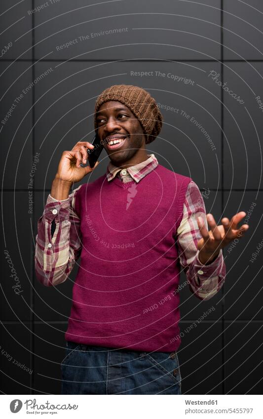 Portrait of smiling man on the phone men males call telephoning On The Telephone calling Adults grown-ups grownups adult people persons human being humans