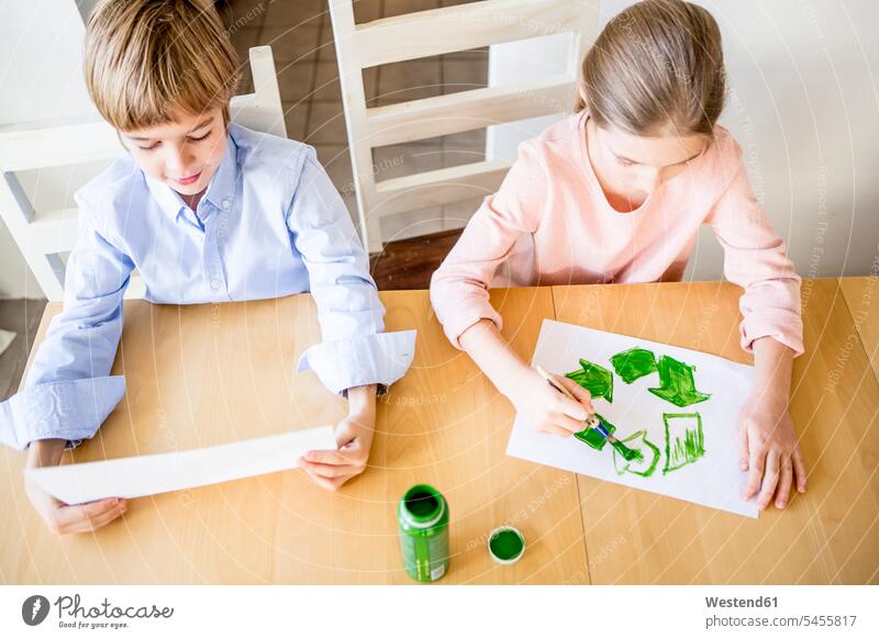 Brother and sister painting recycling symbols ecology recycle sisters brother brothers siblings brother and sister brothers and sisters family families people
