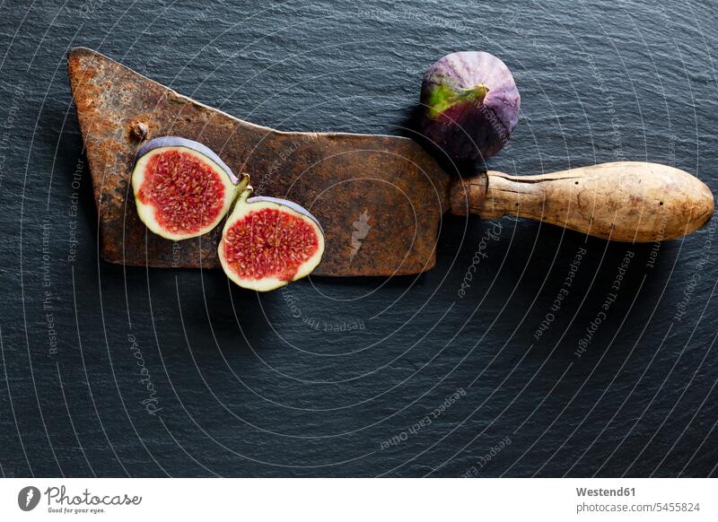 Sliced and whole fig and rusty cleaver on slate food and drink Nutrition Alimentation Food and Drinks Shabby chic Freshness fresh figs Fruit Fruits