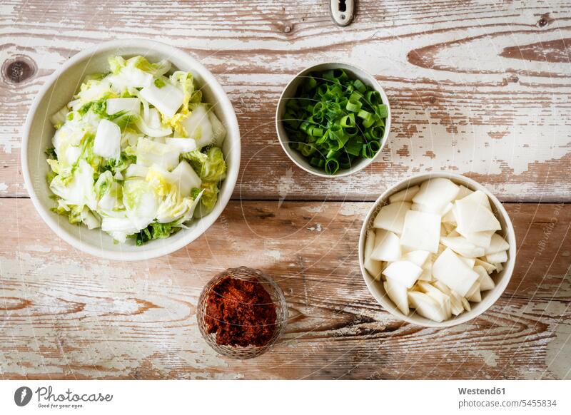 Ingredients for Korean kimchi, Chinese cabbage, radish, spring onions and paprica asian food paprika paprika powder wood wooden delicacy specialty specialties