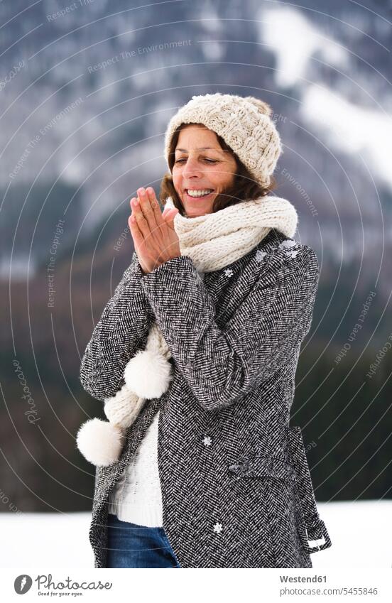 Portrait of happy senior woman in winter - a Royalty Free Stock