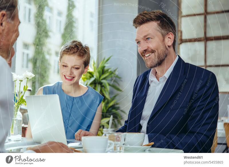 Business people having a meeting in a cafe Business Meeting business conference talking speaking smiling smile Meetings business world business life