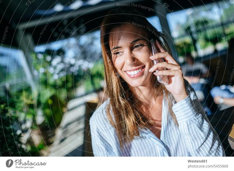 Portrait of smiling woman on the phone females women portrait portraits call telephoning On The Telephone calling Adults grown-ups grownups adult people persons