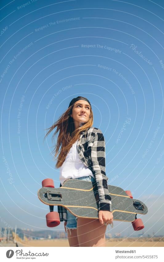 Portrait of young woman with longboard Longboard female skateboarder female skater female skateboarders skaters people persons human being humans human beings