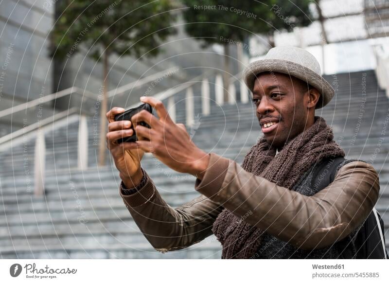 Smiling man taking selfie with smartphone Selfie Selfies men males Smartphone iPhone Smartphones Adults grown-ups grownups adult people persons human being