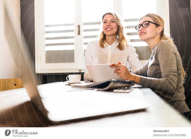 Two businesswomen working together on project businesswoman business woman business women Female Colleague At Work business people businesspeople business world