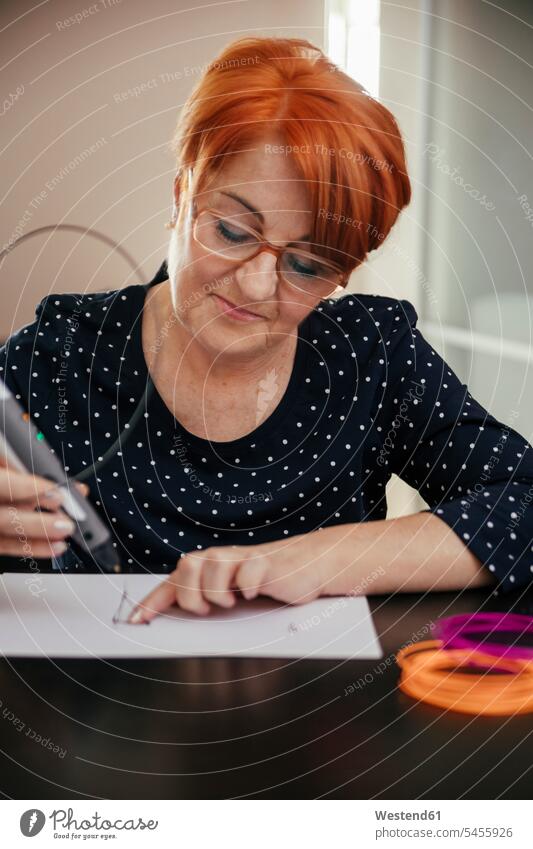 Senior woman drawing with 3D pen pencils pens 3D Pen females women three dimensional Three-Dimensional Shape 3-d 3D printer 3D printers sketching Adults