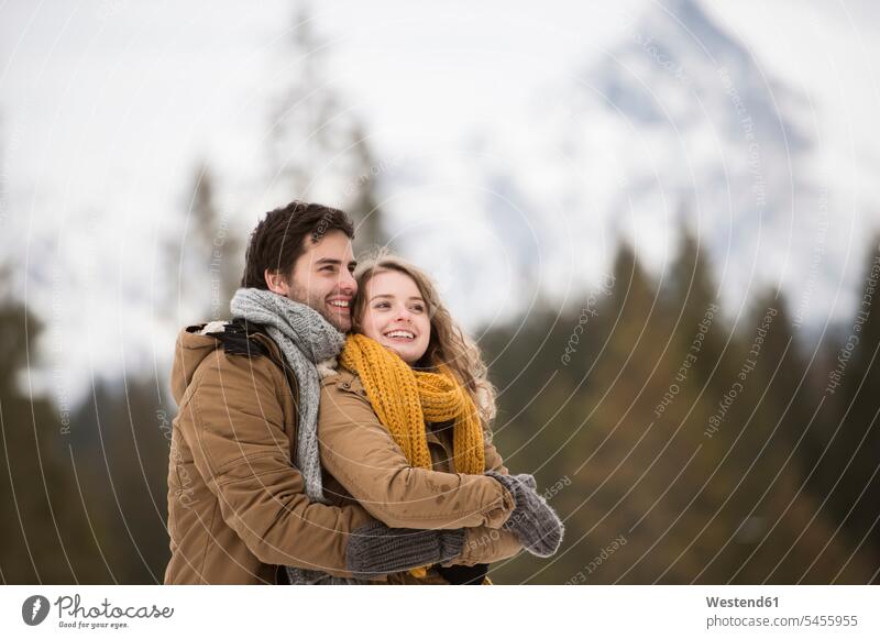 Portrait of happy young couple in winter landscape twosomes partnership couples hibernal people persons human being humans human beings nature natural world