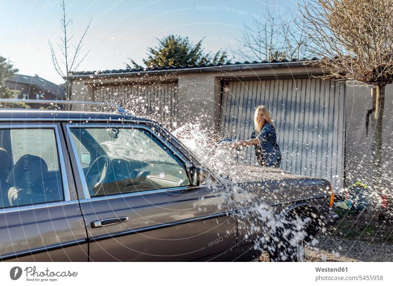 Woman washing her car automobile Auto cars motorcars Automobiles woman females women motor vehicle road vehicle road vehicles motor vehicles Adults grown-ups