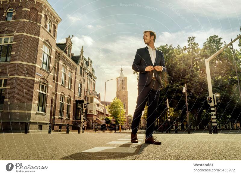 Netherlands, Venlo, businessman standing on a street city town cities towns Businessman Business man Businessmen Business men road streets roads outdoors