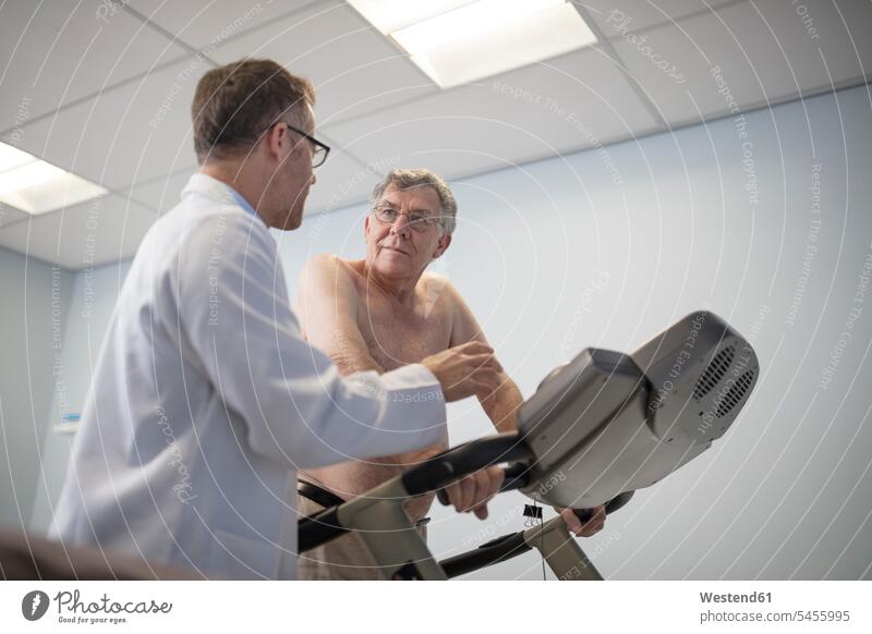 Doctor talking to senior patient on treadmill fit patients doctor physicians doctors practice illness disease Sickness illnesses diseases