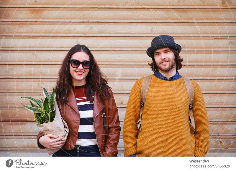 Portrait of smiling young couple twosomes partnership couples people persons human being humans human beings smile portrait portraits standing front view