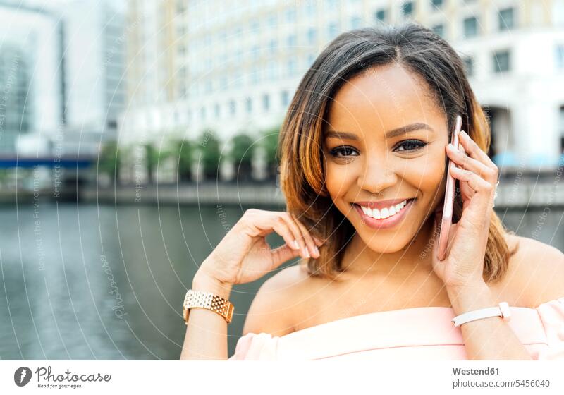 Portrait of smiling woman talking on the phone in the city call telephoning On The Telephone calling smile mobile phone mobiles mobile phones Cellphone