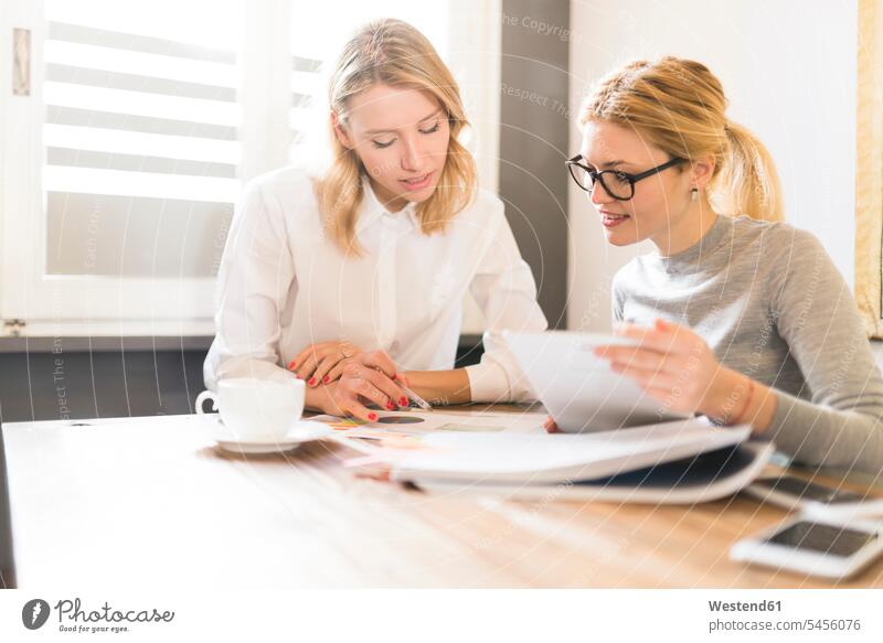 Two businesswomen working together on project At Work Female Colleague businesswoman business woman business women colleagues business people businesspeople