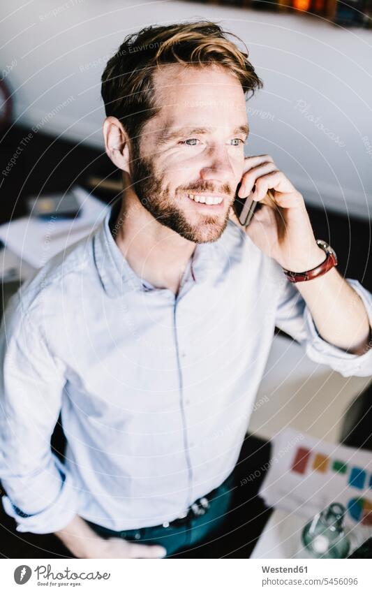 Portrait of smiling businessman on the phone call telephoning On The Telephone calling Businessman Business man Businessmen Business men architect architects