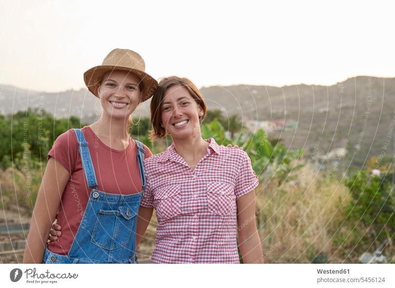 Portrait of two happy young farmers female friends portrait portraits mate friendship smiling smile woman females women agriculturists agriculture Adults