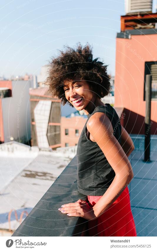 Relaxed woman standing on rooftop in Brooklyn females women house top Roof Top roofs Joy enjoyment pleasure Pleasant delight attractive beautiful pretty
