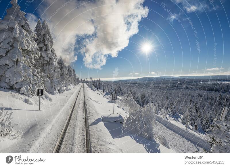 Germany, Saxony-Anhalt, Harz National Park, Brocken, rail tracks of Harz Narrow Gauge Railway in winter against the sun National Parks rural scene