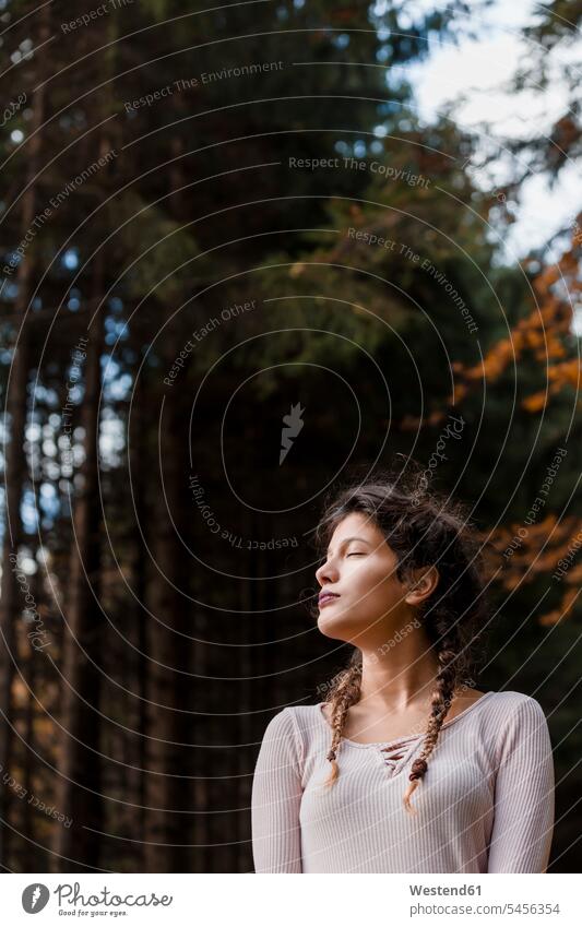 Portrait of young woman with eyes closed in the woods portrait portraits forest forests females women Adults grown-ups grownups adult people persons human being