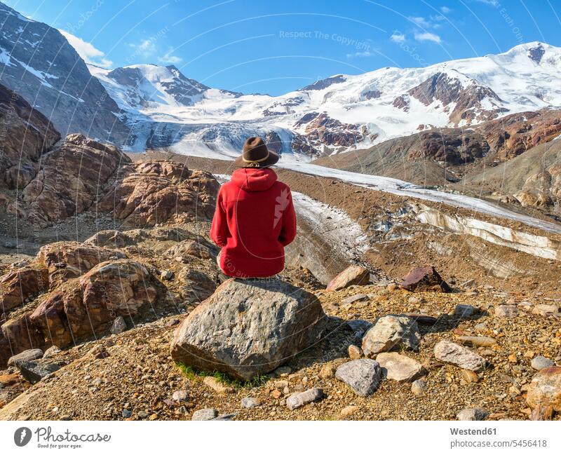 Italy, Lombardy, Cevedale Vioz mountain crest, hiker resting at Forni glacier National Park National Parks recovering Stelvio National Park nature tourism