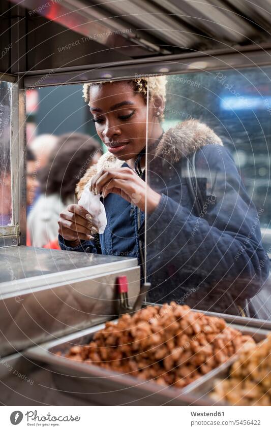 Portrait of young woman buying food on stall portrait portraits stand stands stalls females women Adults grown-ups grownups adult people persons human being