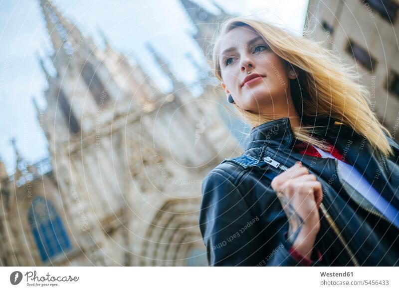 Spain, Barcelona, portrait of young woman with cathedral in the background portraits females women Adults grown-ups grownups adult people persons human being