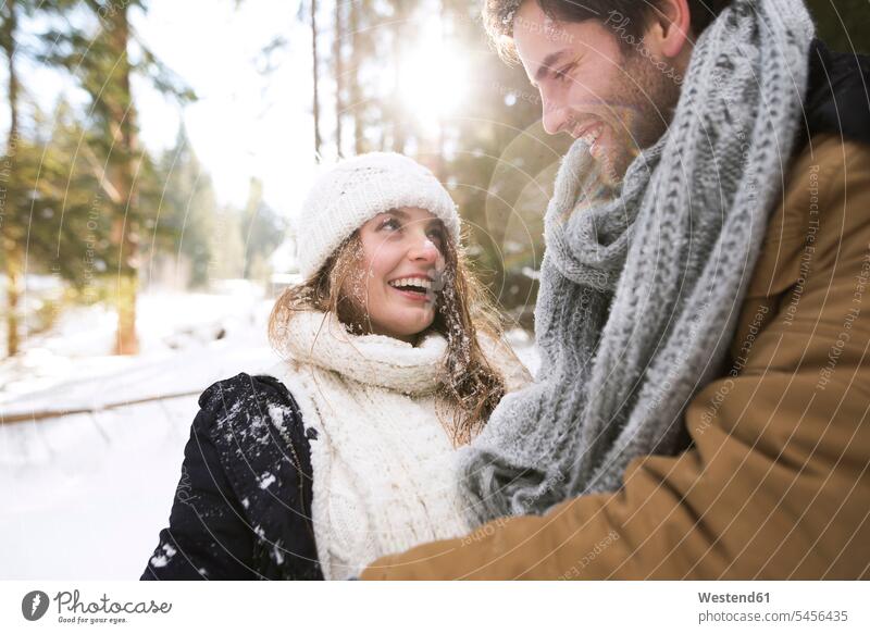 Happy young couple face to face in winter twosomes partnership couples people persons human being humans human beings happiness happy laughing Laughter looking