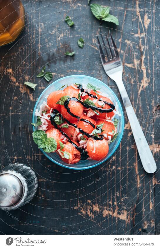 Watermelon salad with eschalot, mint, olive oil and balsamico in bowl Bowl Bowls healthy eating nutrition wooden garnished juicy sphere ball balls ball-shaped