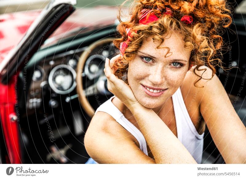 Portrait of smiling redheaded woman in sports car smile automobile Auto cars motorcars Automobiles portrait portraits females women motor vehicle road vehicle