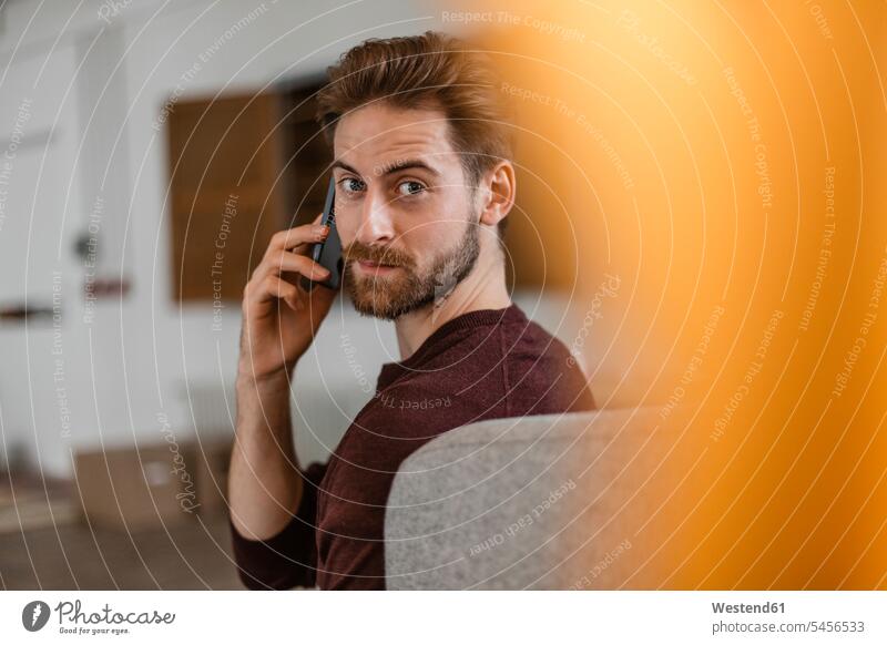 Portrait of young man on the phone call telephoning On The Telephone calling men males telephone call Phone Call using phone Using Phones Adults grown-ups
