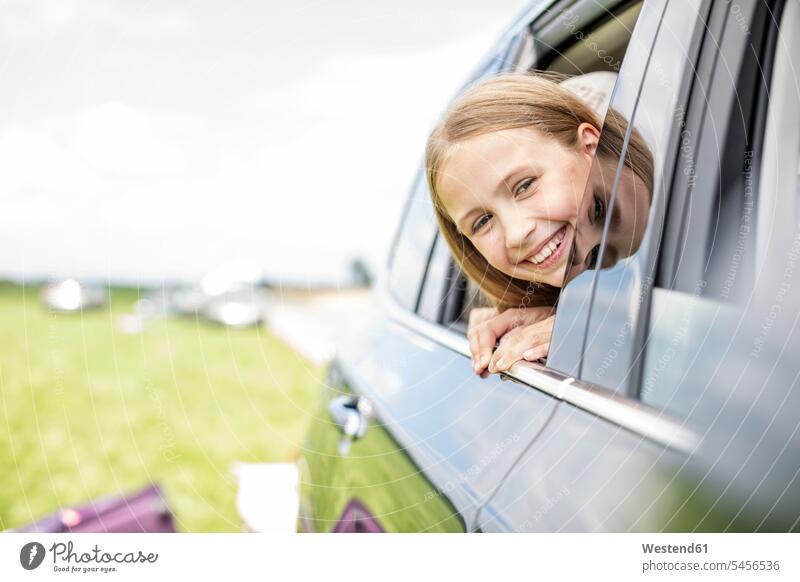 Girl sitting in car, looking out of window Seated vacation Holidays automobile Auto cars motorcars Automobiles Road Trip roadtrip Road-Trip smiling smile girl