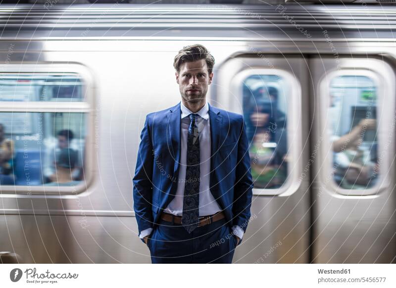 Businessman standing in front of leaving metro train commuter commuters the metro Business man Businessmen Business men Manhattan attractive beautiful pretty