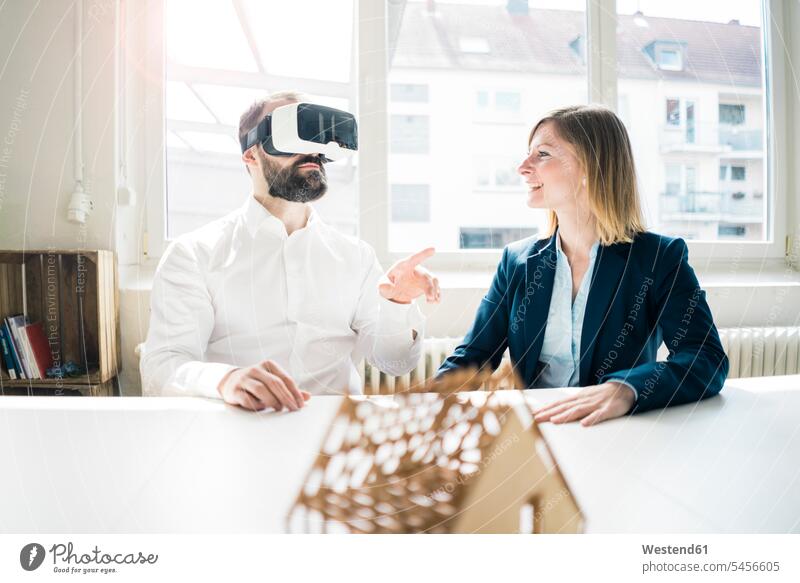 Woman and man with house model and VR glasses in office specs Eye Glasses spectacles Eyeglasses smiling smile models offices office room office rooms