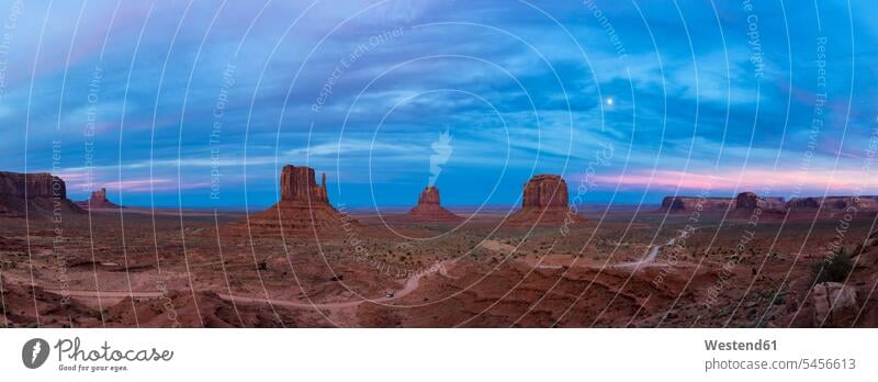 USA, Colorado Plateau, Utah, Arizona, Navajo Nation Reservation, panorama of Monument Valley at dawn with full moon rock formation Rock Formations