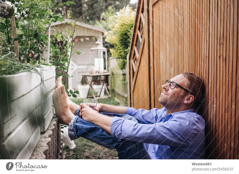 Man relaxing in garden relaxed relaxation man men males gardens domestic garden Adults grown-ups grownups adult people persons human being humans human beings