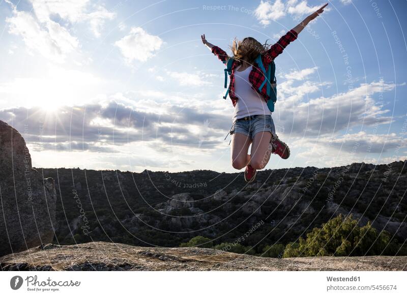 Spain, Madrid, young woman jumping during a trekking day Leaping females women mountain mountains Joy enjoyment pleasure Pleasant delight hiking hike rock rocks