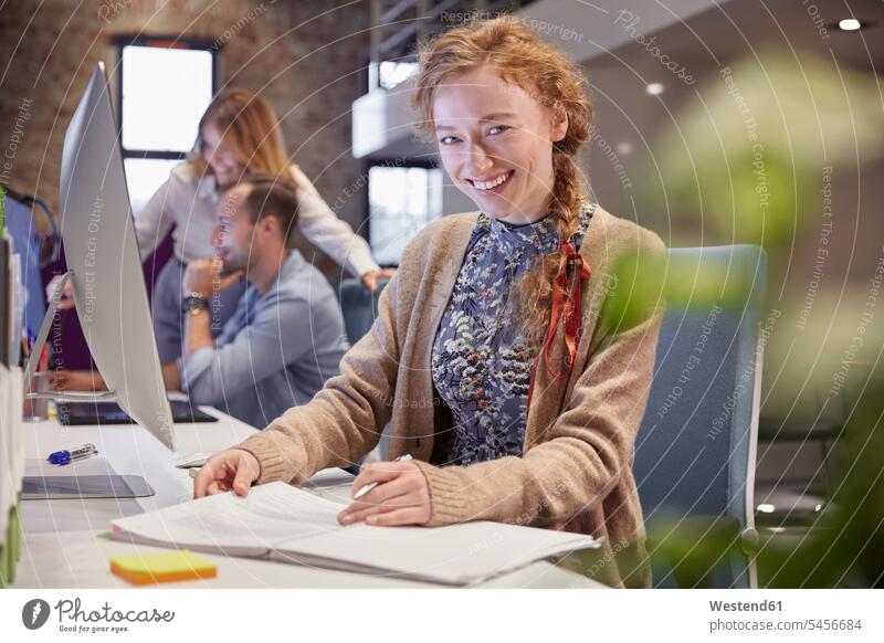 Young woman working in modern creative office, usine laptop young women young woman offices office room office rooms creative professional Creative People