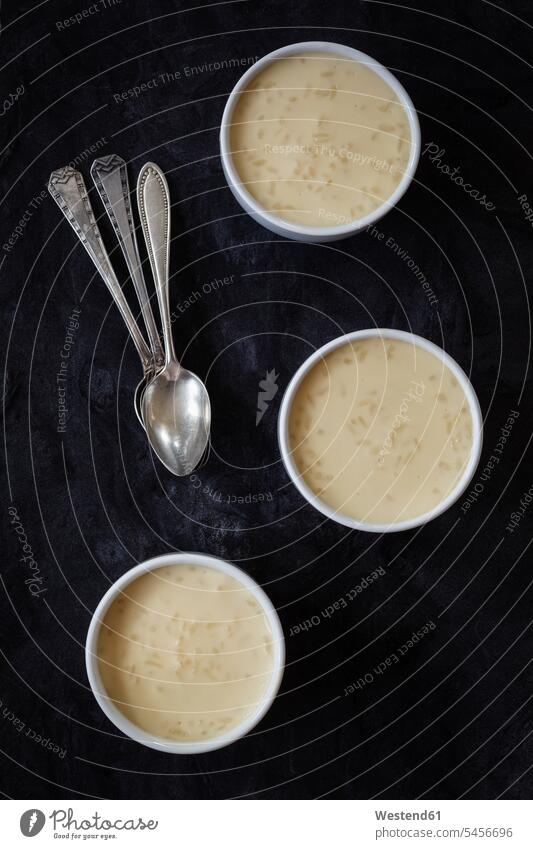 Baked pudding rice Bowl Bowls ready to eat ready-to-eat black background black backgrounds arrangement grouping tea spoon Teaspoon tea spoons Dessert Afters