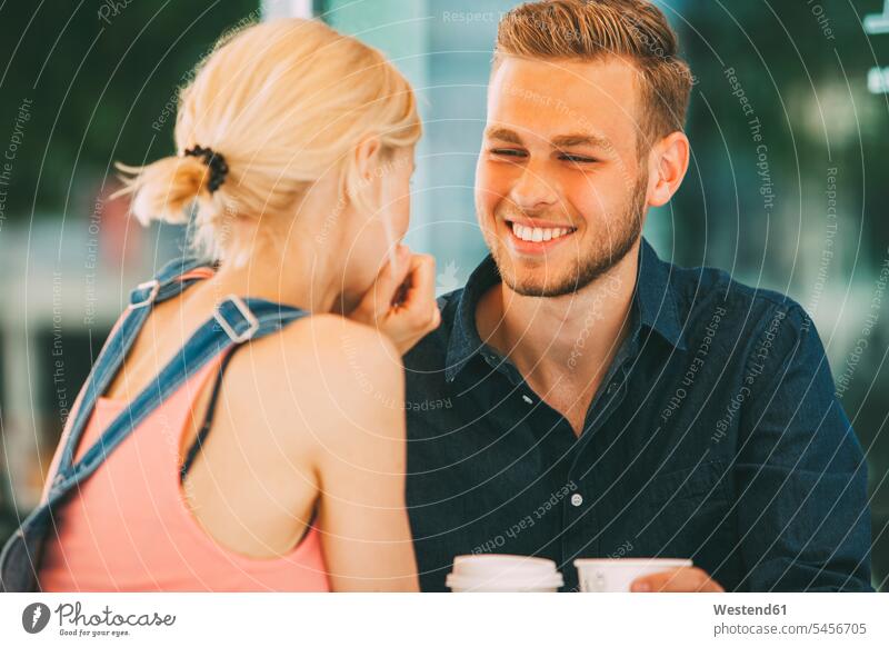 Portrait of happy young man drinking coffee with his girlfriend couple twosomes partnership couples people persons human being humans human beings happiness