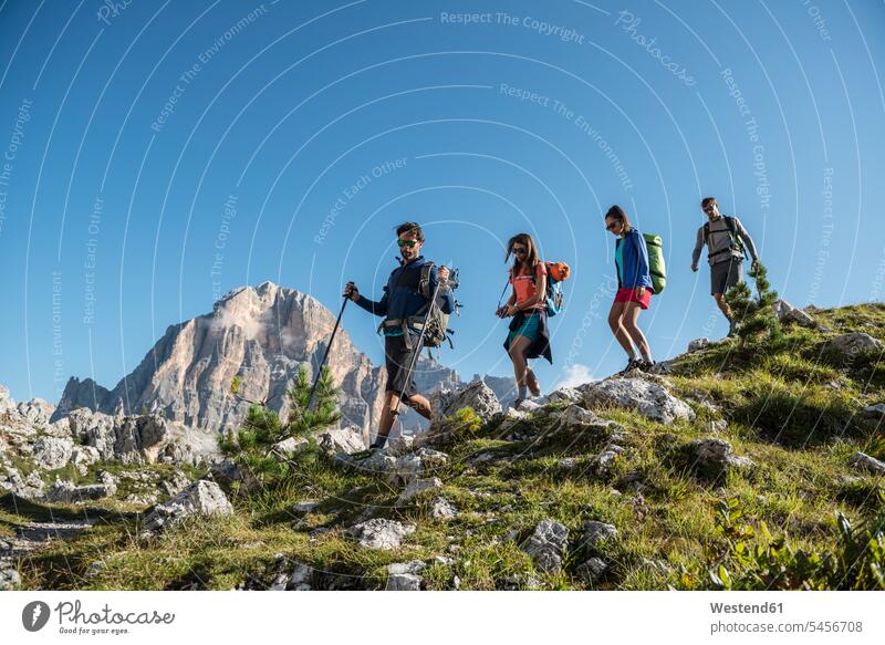 Italy, Friends trekking in the Dolomtes active friends mountain hike Dolomites Dolomite Alps hiking climber alpinists climbers mountaineer Mountain Climber