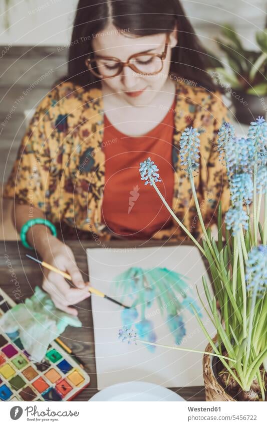 Young woman painting plants with water colors brush brushes watercolours watercolors Watercolor Paint Watercolour Watercolor Paints Grape hyacinth