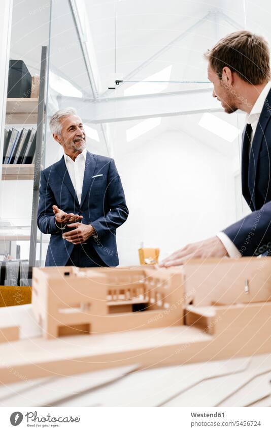 Two businessmen with architectural model in office models architects colleagues smiling smile offices office room office rooms Businessman Business man