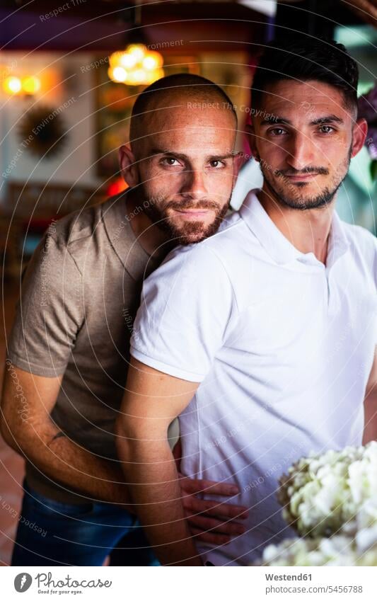 Portrait of gay couple in a bar happy Emotions Feeling Feelings Sentiment Sentiments loving closeness propinquity lyrical Romance stand homosexually queer