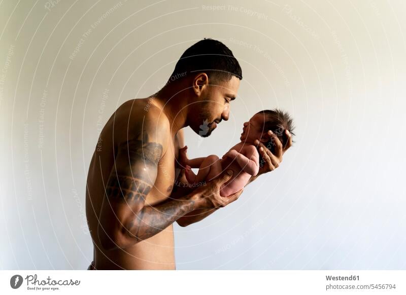 Affectionate father holding his crying nude newborn baby pa fathers daddy dads papa Security Secure affectionate tender loving caressing 0-1 months close